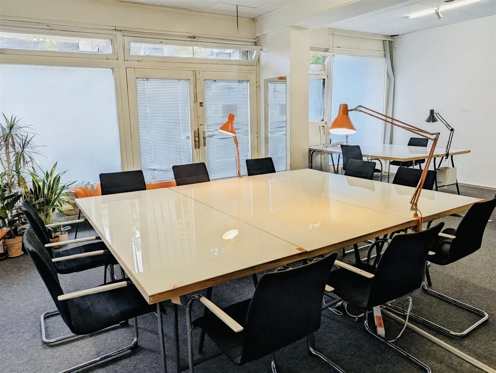 Meeting and desks setup, staged as an evening event scene